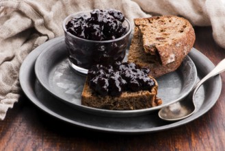 Bread with blueberry jam on the plate