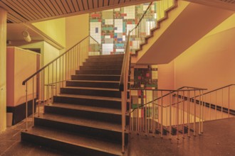Stairwell with coloured tiles and warm light, Bad am Südpark, Essen-Kray, North Rhine-Westphalia,