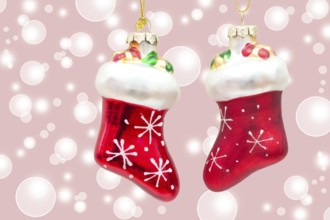 Two little red boots on pink bokeh background two little boots over pink bokeh background