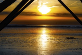Sunset over the mudflats with dramatic colours and silhouettes in the foreground, Dorum-Neufeld
