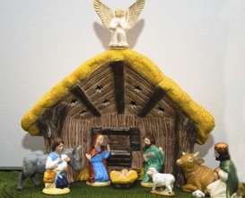Nativity scene with painted figures of Christmas in the stable - close-up