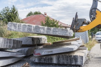 Transporting natural stone granite with a wheel loader - Front loader on construction site