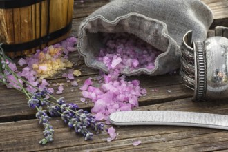 Scattered, sea salt spa treatment on wooden background