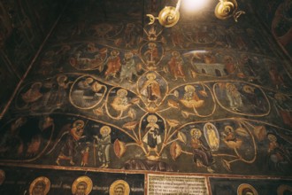 Church wall with paintings from the lives of the saints.