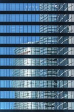 Office building and reflections against blue sky. Business and finance concept