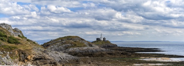 A panorama view of the Mumbles headland with the historic lighthouse in Swansea Bay