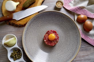 Steak Tartare raw meat recipe with egg yolk modern cuisine