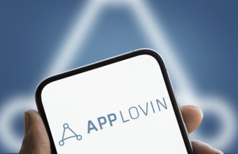 App lovin logo is displayed on smartphone. AppLovin Corporation is an American mobile technology