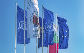 The Flags of European Union, United Nations, Unesco, Bulgaria, and Nessebar city waving in the wind