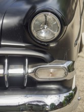 Close-up of a black classic car with focus on the headlights and chrome, Duisburg, Ruhr area,