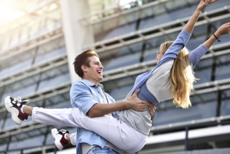Beautiful couple in love dating outdoors and smiling. Beautiful girl embraces the guy