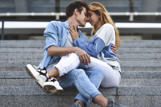 Happy to spending time together. Young beautiful couple outdoor fashion portrait. Attractive boy