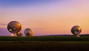 Large parabolic antenna at dusk