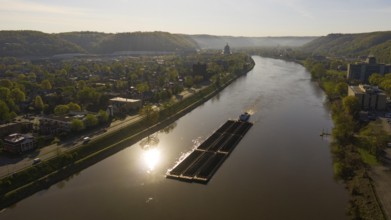 Charleston West Virgina ia an active seaport here a barge moves coal around