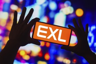 In this photo illustration, the EXL Service logo is displayed on a smartphone screen