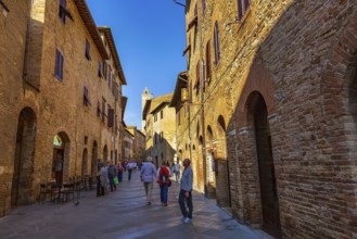San Gimignano, Tuscany, Italy, October 25, 2018: Old medeival street and tower in typical Tuscan