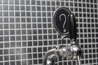 Beer tap with medallion with question mark as description