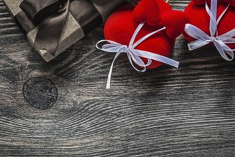 Present box red hearts on vintage wooden board celebrations concept