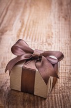 Single vintage gift box on old wooden board