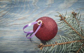 Red Christmas ball pine brunch on wooden board holidays concept
