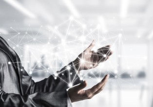 Business woman in suit keeping white social media network structure in hands with office view on
