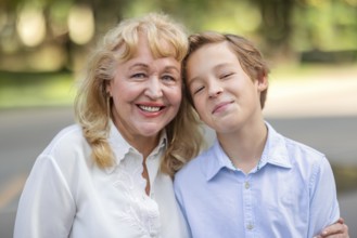 Teenager boy is happy to spend time with grandma. Family portrait is full of happiness and warmth