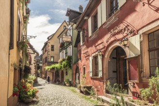 Alley with historic houses in the old town centre of Riquewihr, Alsace, France, Europe