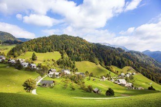 Small village in mountain valley. Picturesque Julian Alps. Beautiful autumn day. Charming pastoral.
