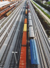 Cargo trains close-up. Aerial view of colorful freight trains on the railway station. Wagons with