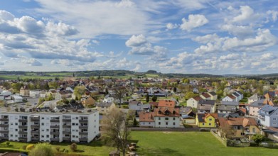 Urban landscape with varied roofs and green surroundings under a changing sky, Mitterteich, Upper