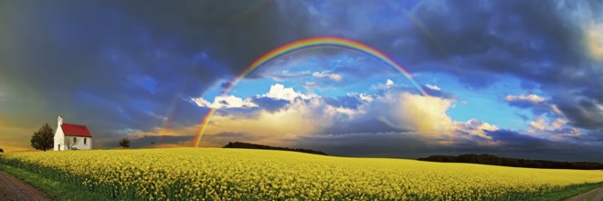 Panorama, chapel and rainbow over a rapeseed field