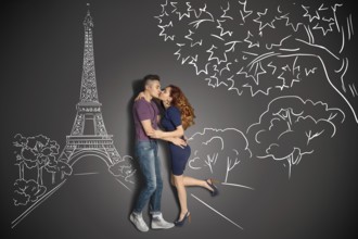 Happy valentines love story concept of a romantic couple in Paris kissing under the Eiffel Tower