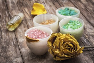 Sea aromatic salt for Spa treatments on the background of yellow rose buds