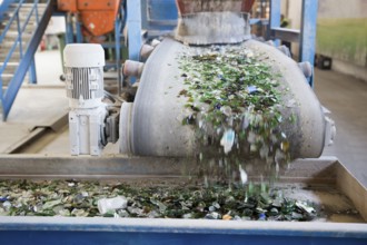 Glass particles for recycling in a machine in a recycling facility. Different glass packaging