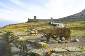 Autumn morning and mountain landscape by the sea, old fortress on the rocks above the sea