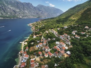 Coast of Dobrota on the shore of the Bay of Kotor at the foot of the mountains. Montenegro., Kotor