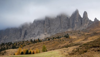 Mountain landscape of dolomites covered with fog Italian alps in autumn. Nature scenery Italy.