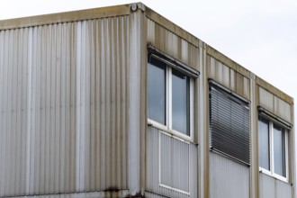 Corner view of an industrial building with a metal exterior and several windows