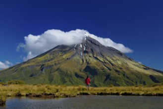 A man in front of Mount Taranaki in New Plymouth, New Zealand, Oceania