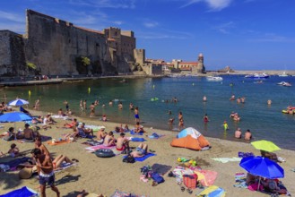 People having fun on the beach in summer in Collioure, France, Europe