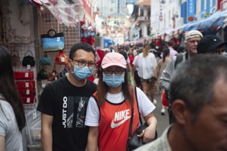 24.01.2020, Singapore, Republic of Singapore, Asia, Pedestrians wearing face masks stroll through a