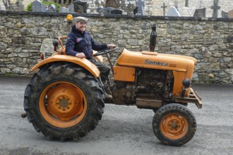 Old tractor Someca in front of church and chapel Sainte Nonne, vintage car meeting Dirinon,