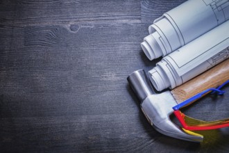 Copyspace blueprints hammer goggles on wood board