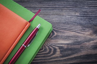 Diary books brio pen on wooden board education concept