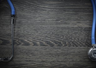 Stethoscope on vintage wooden board medicine concept