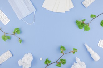 Creative flat lay concept of seasonal spring pollen allergy with napkins, pills, face mask, drops