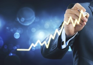 Close view of businessman drawing on screen growing graph