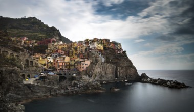Picturesque and romantic village of Manarola with colourful houses and small beautiful port at