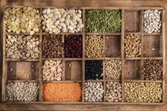 Presentation in an old wooden container varieties of dried legumes