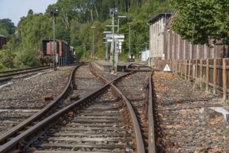 Rail switches run alongside a building between trees, bochum, westphalia, germany